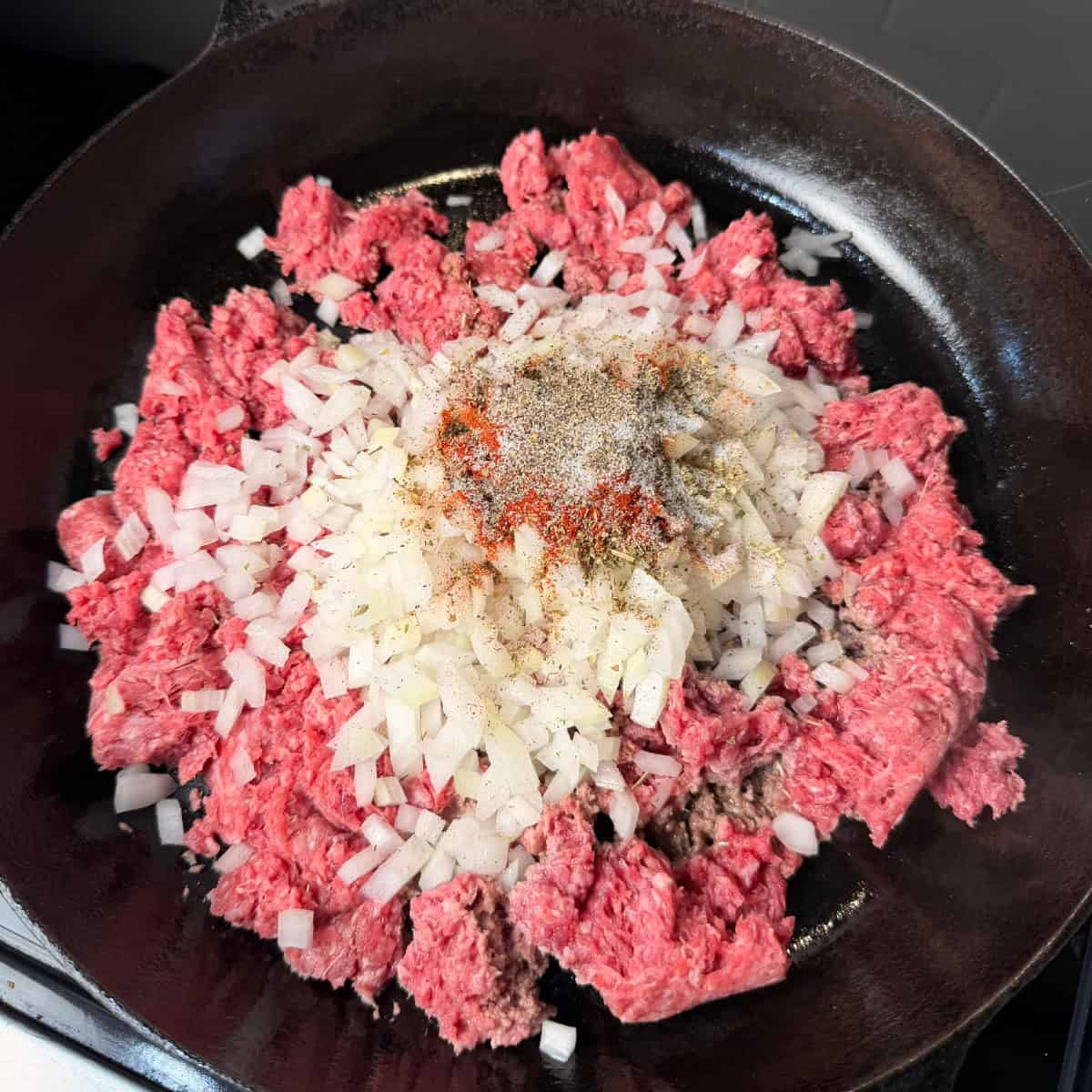 Ground beef, onions, seasonings in cast iron skillet
