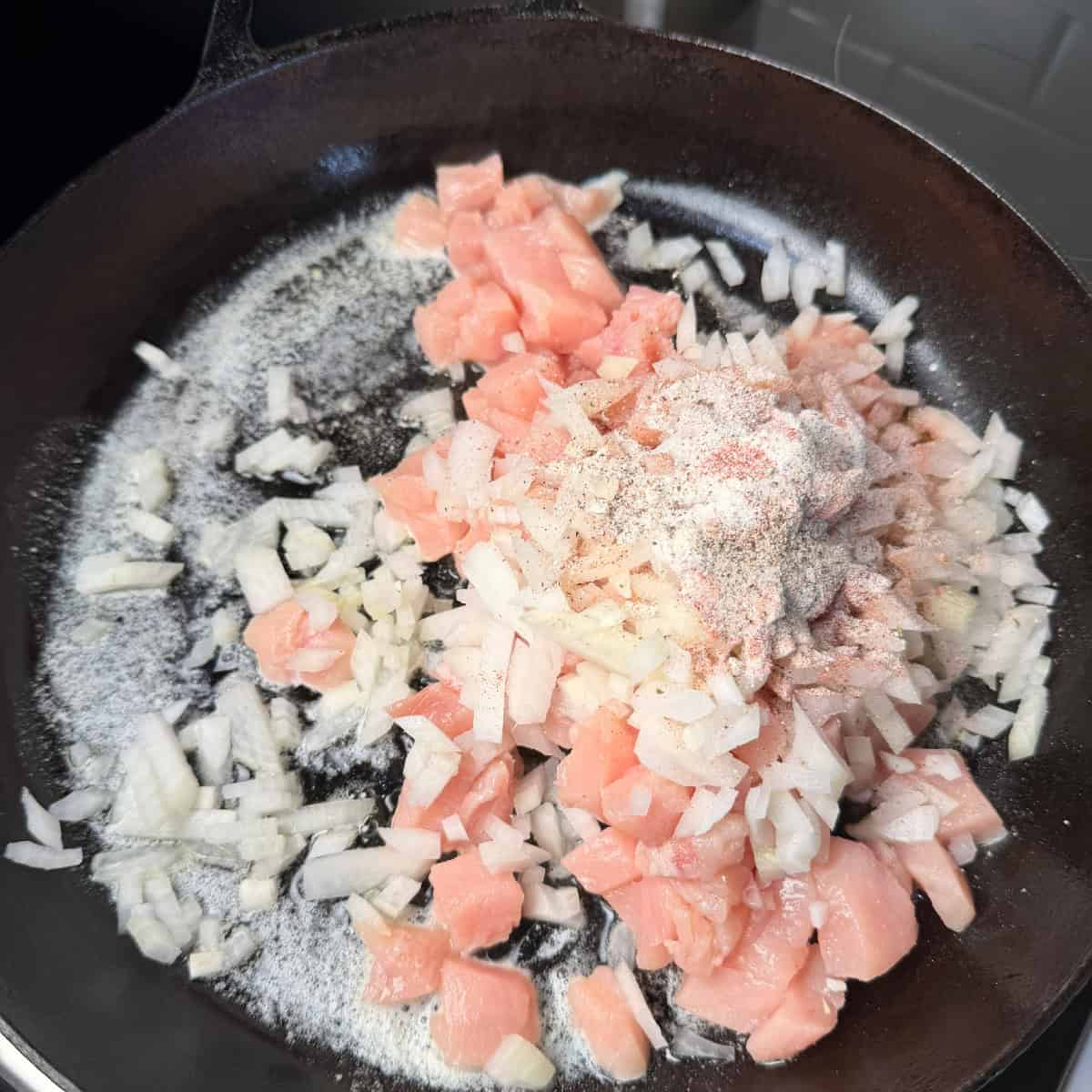 Chicken, onions, butter in skillet