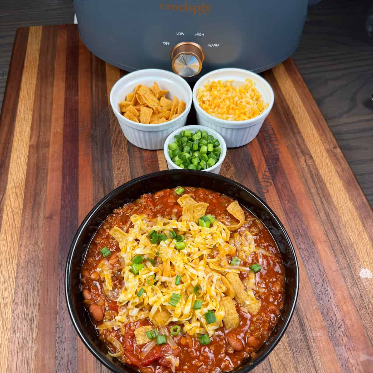 Chili with Fritos, cheese, and green onions