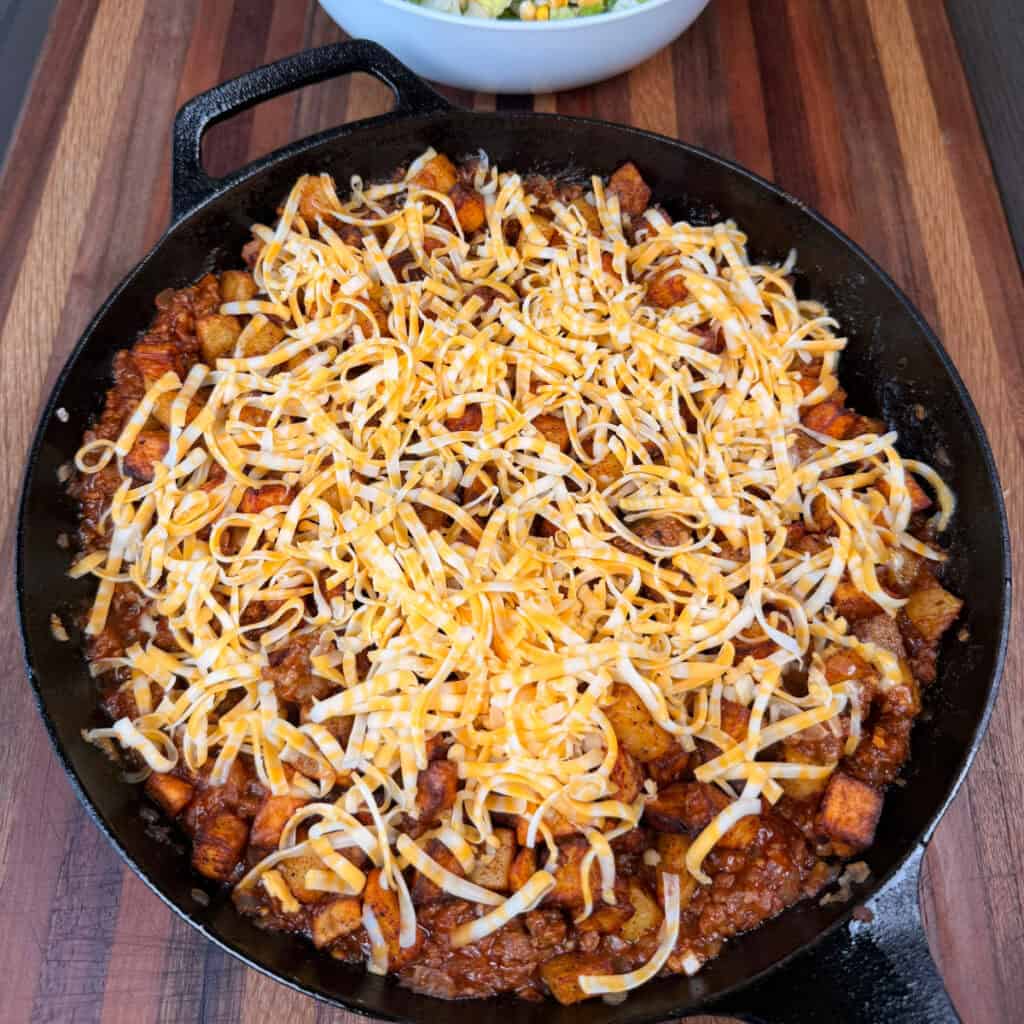 Sloppy Joe Potato Skillet topped with cheese