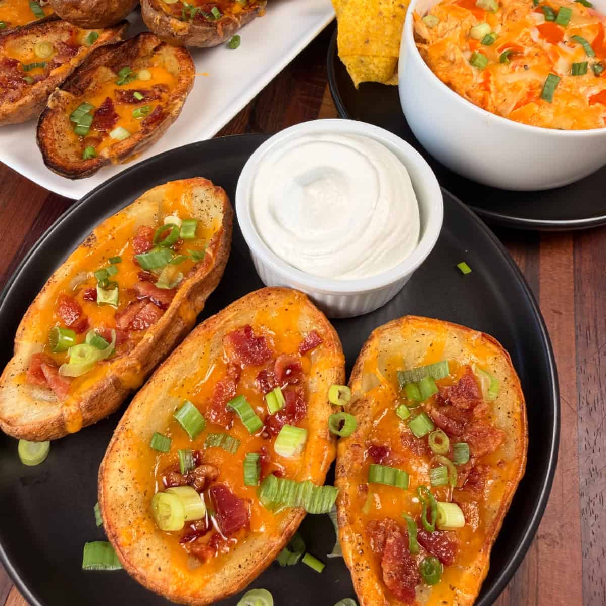 Loaded potato skins with sour cream and buffalo chicken dip