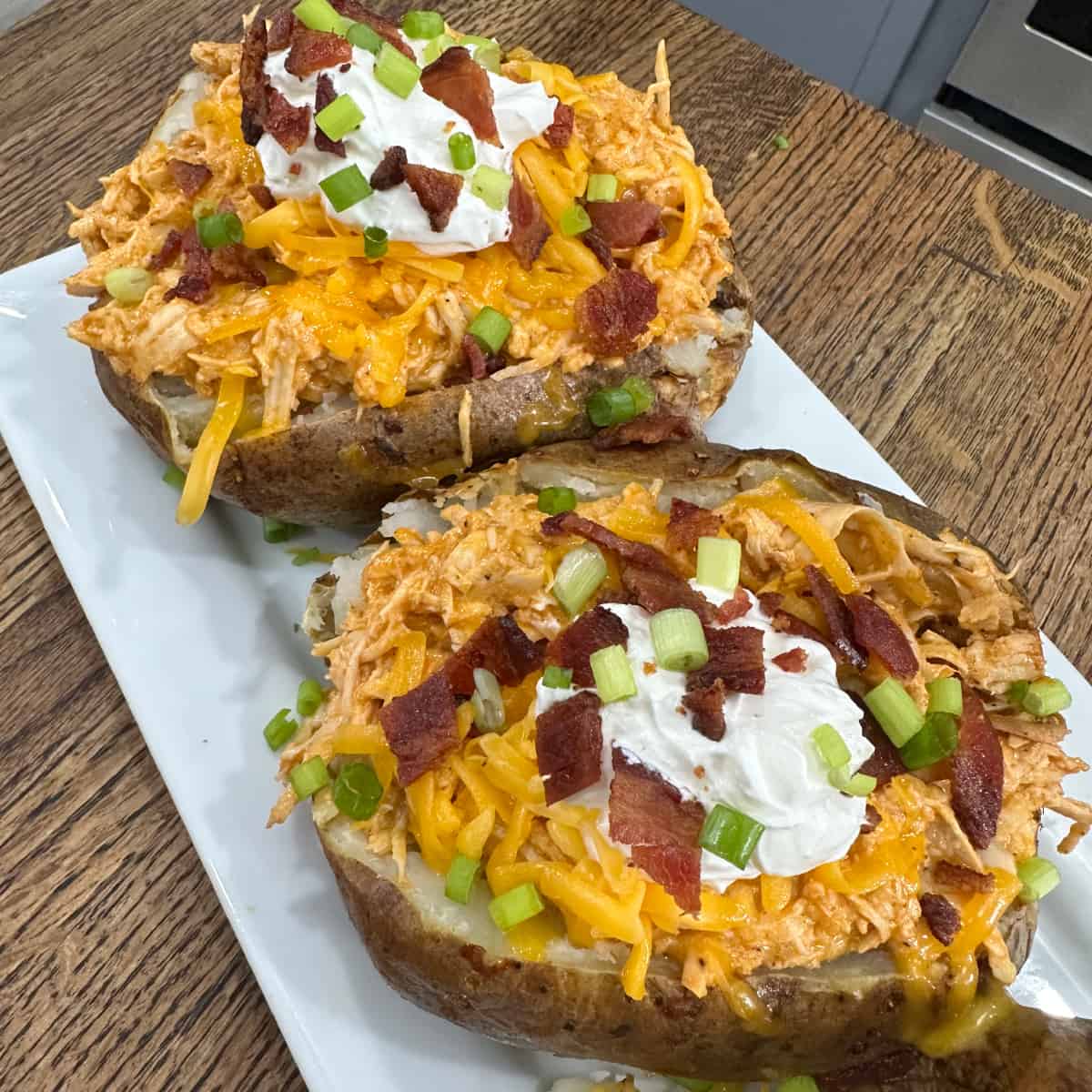 Crockpot Buffalo Chicken Baked Potatoes - Cooking in the Midwest