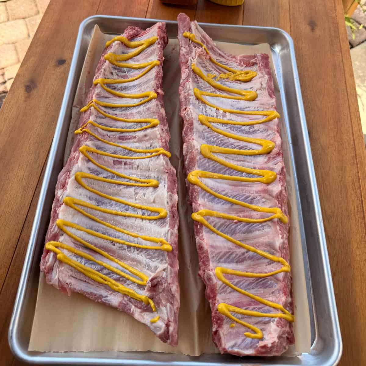 Baby Back Ribs coated in yellow mustard