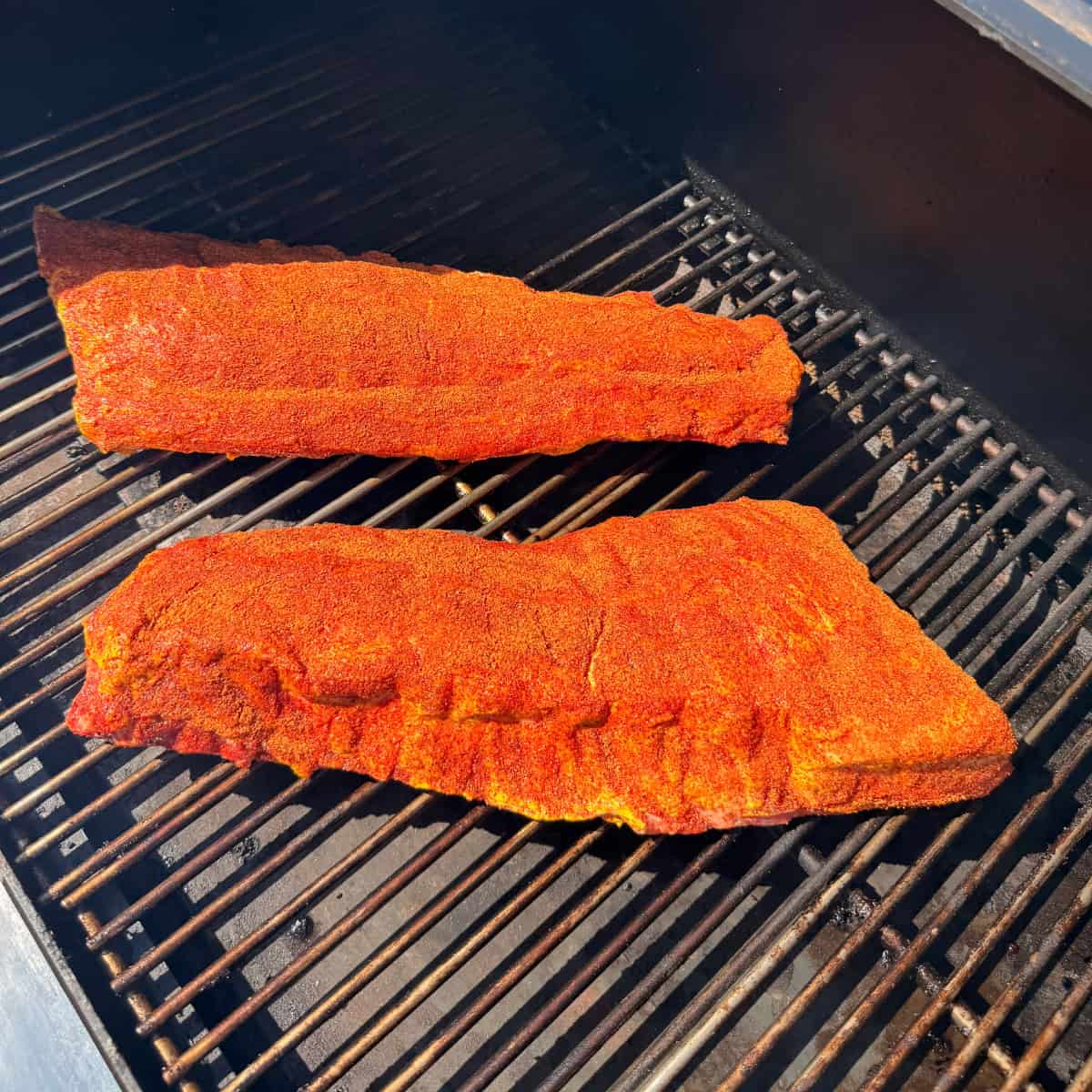 Baby Back Ribs seasoned and on Smoker
