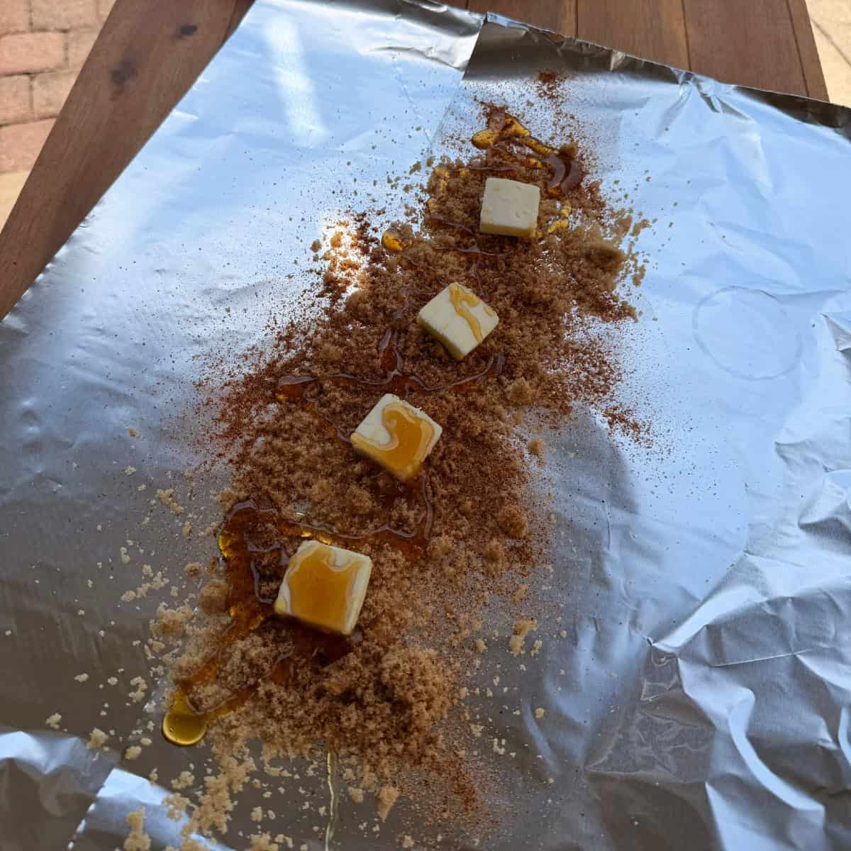 Aluminum foil with butter, brown sugar, BBQ rub