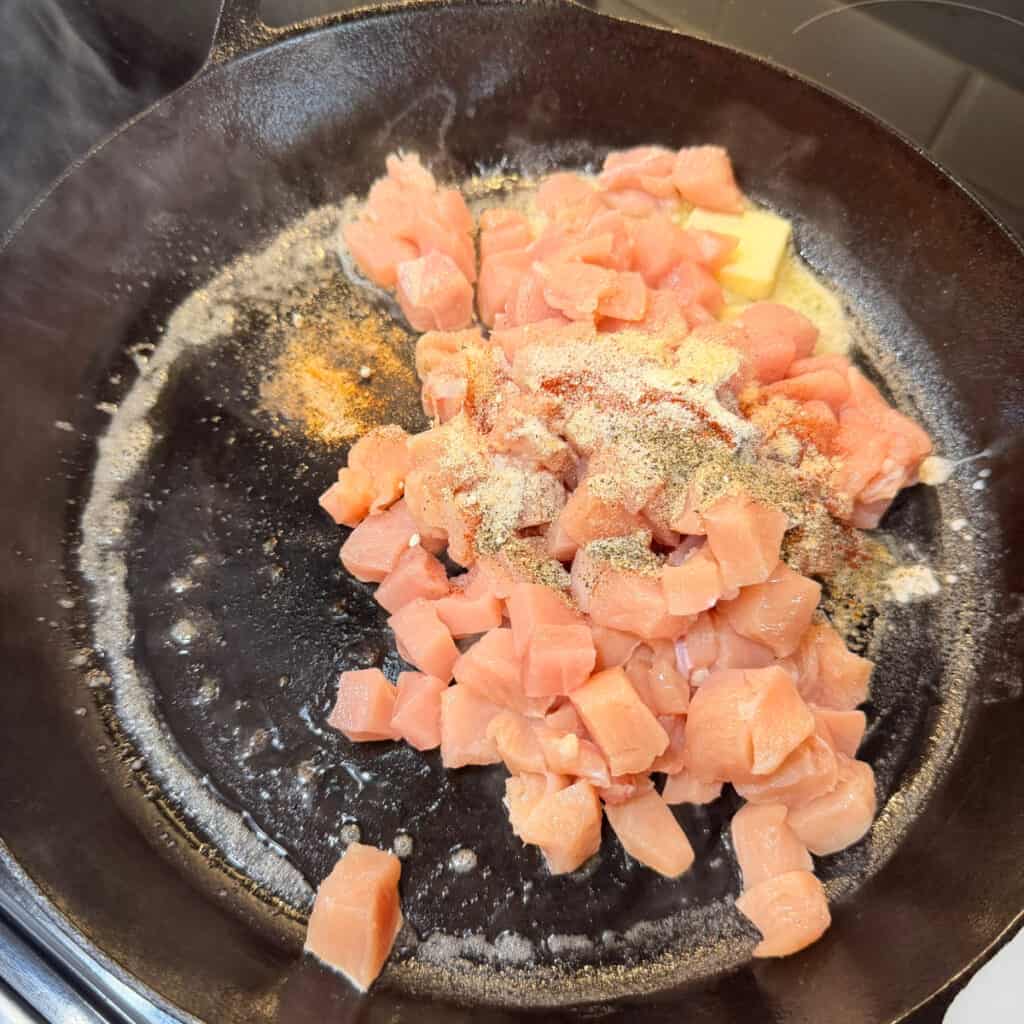 Chicken, butter, and seasonings in skillet