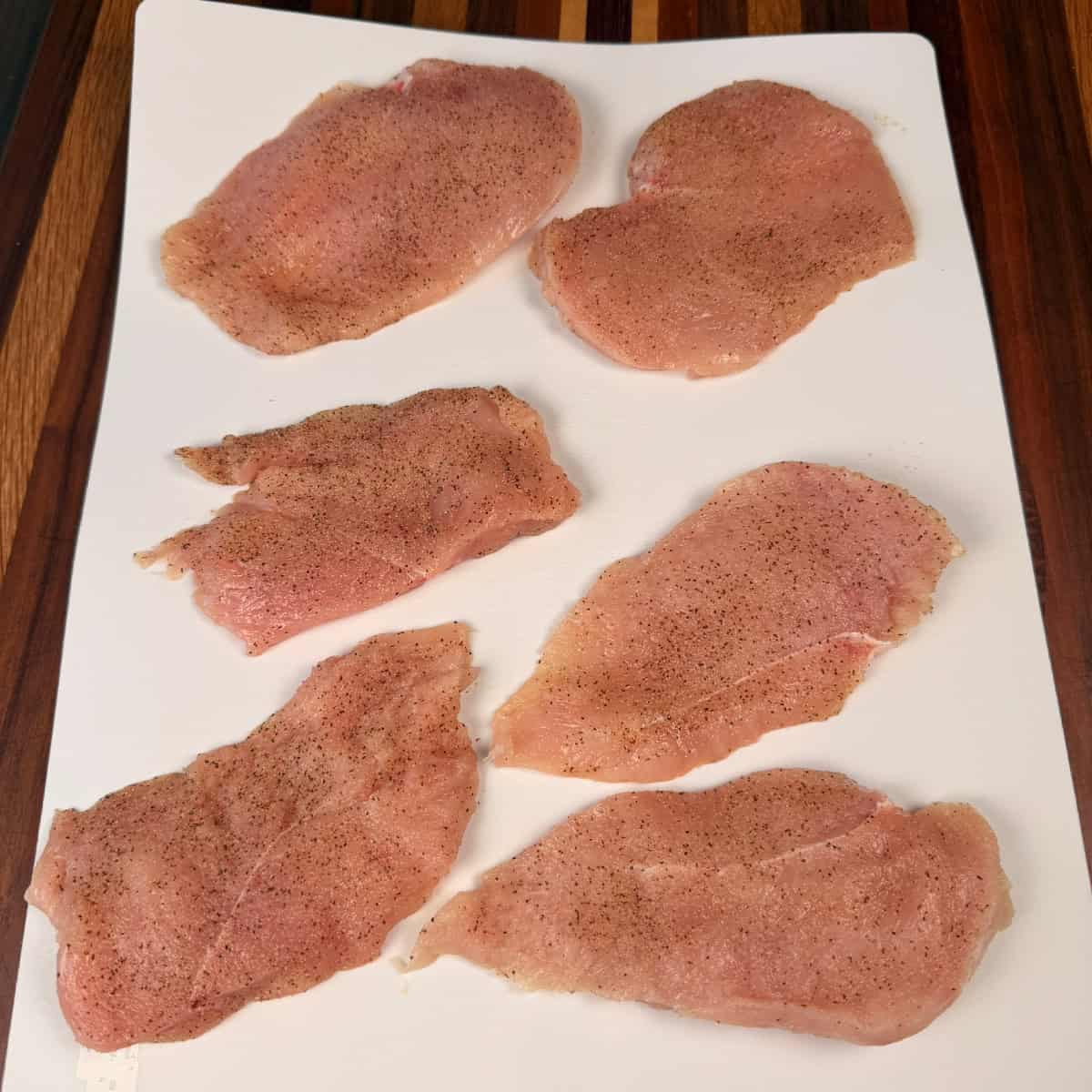 Seasoned chicken on cutting board