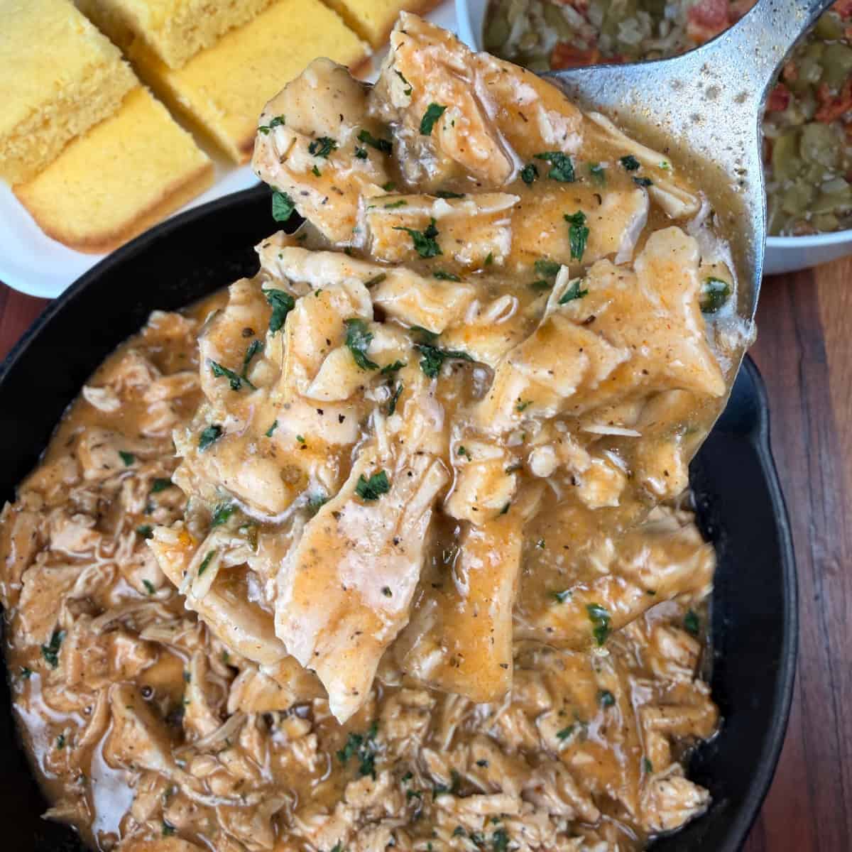 Up close scoop up of chicken and gravy on a spoon