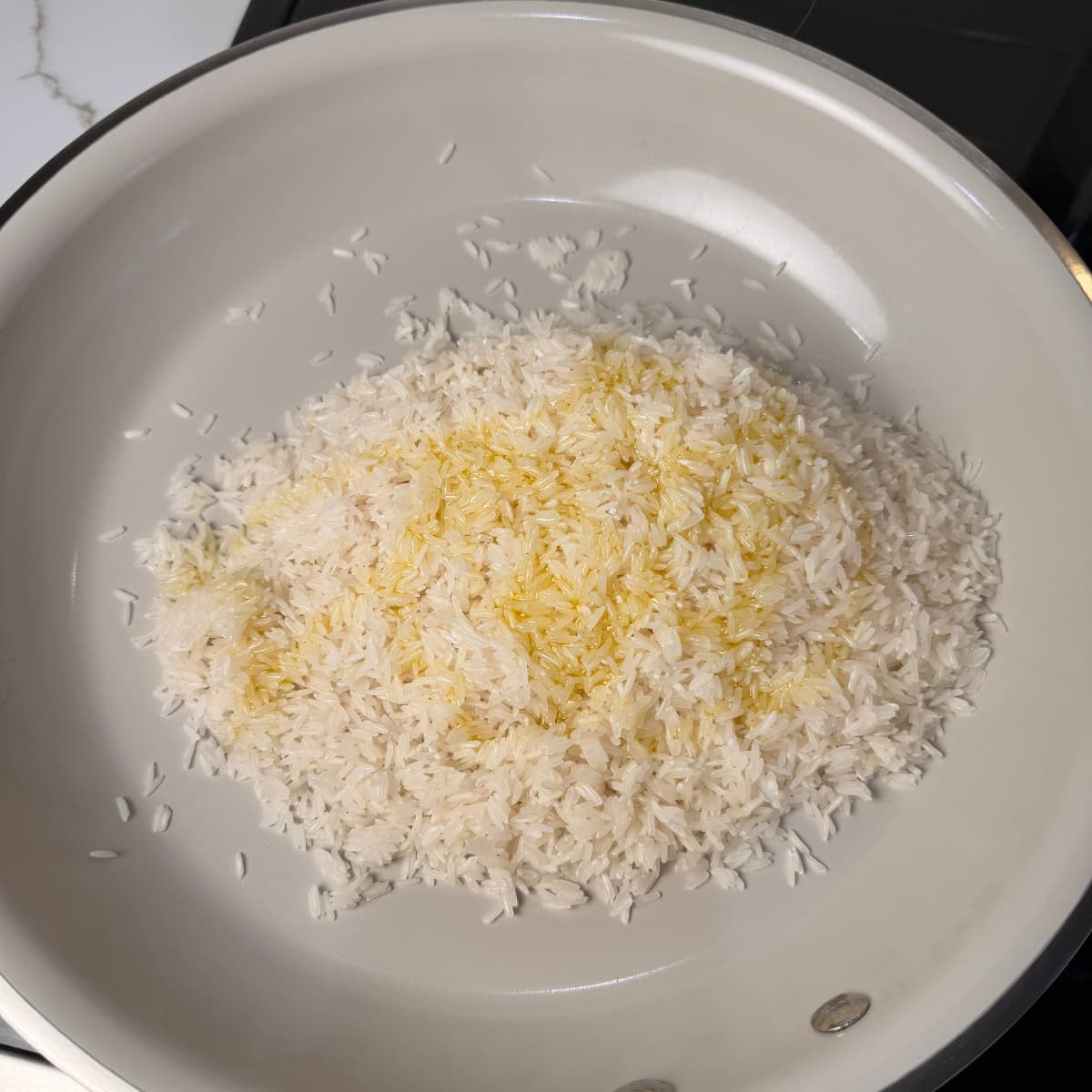 Jasmine rice in skillet with olive oil 