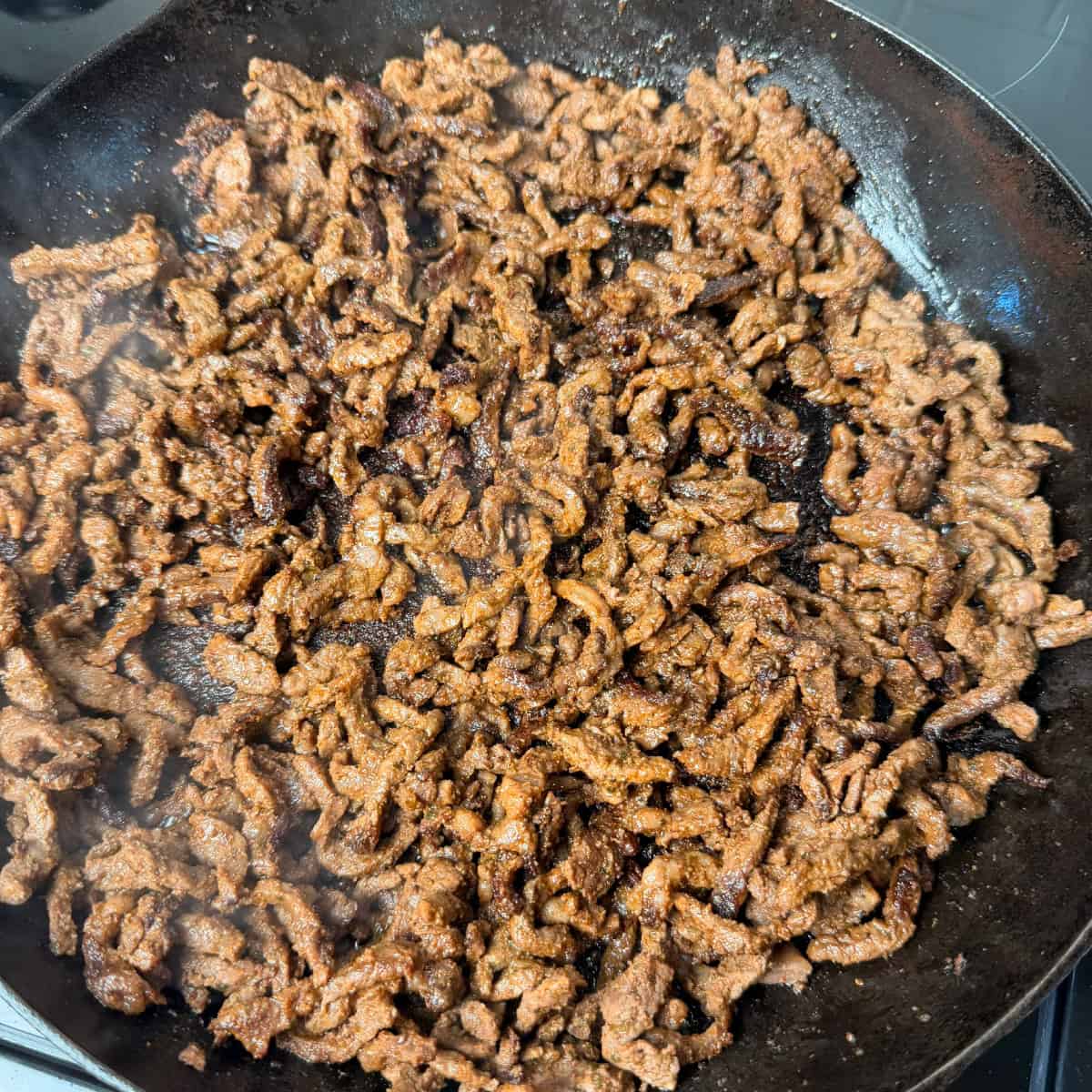 Cooked Strip Steak in cast iron skillet