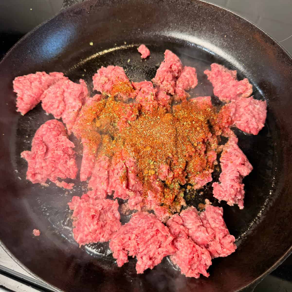 Ground beef in cast iron skillet with taco seasoning