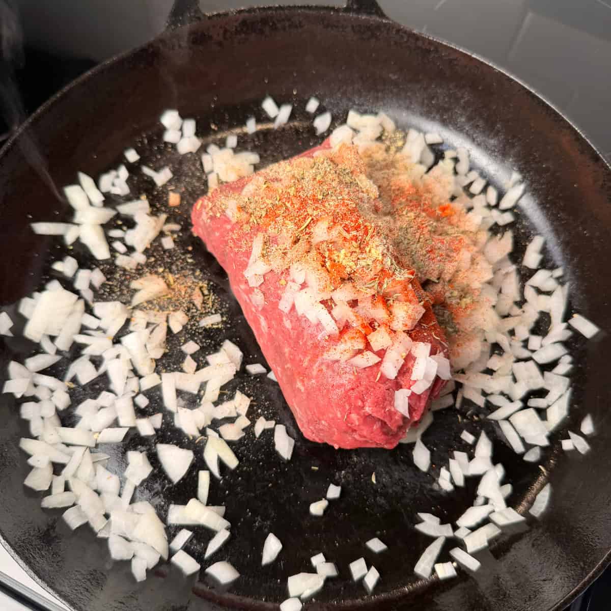 Ground beef, onions, seasonings in skillet