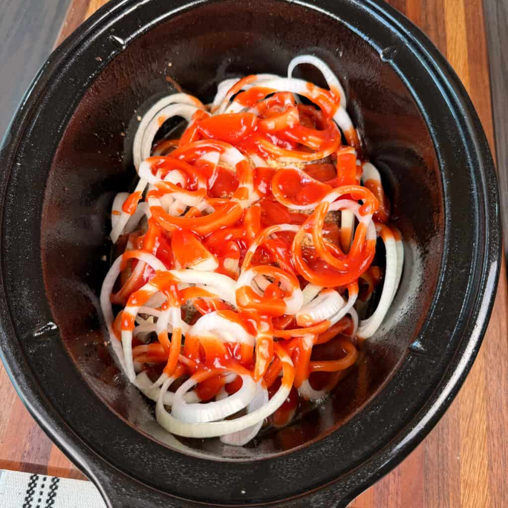 Roast with Arby's sauce and sliced onions in crockpot