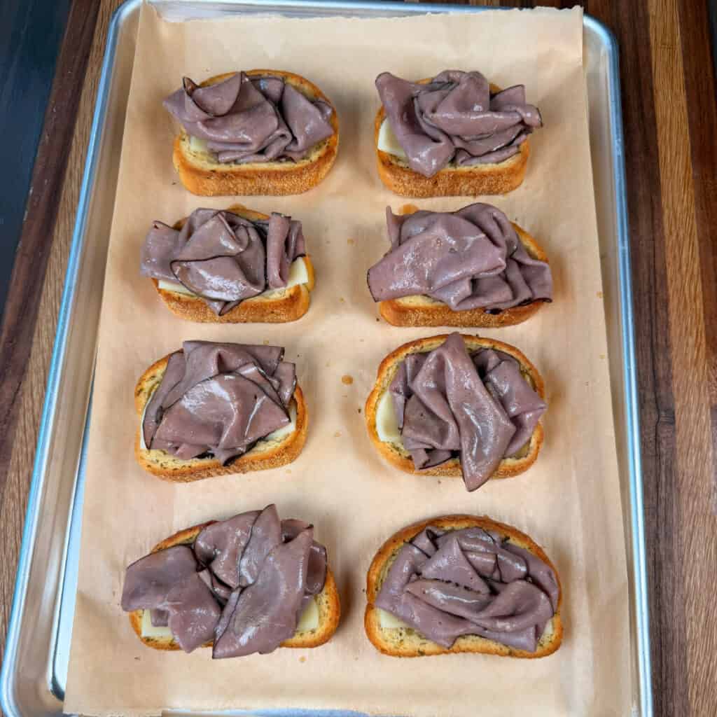 Garlic Toast with cheese and roast beef on sheet pan