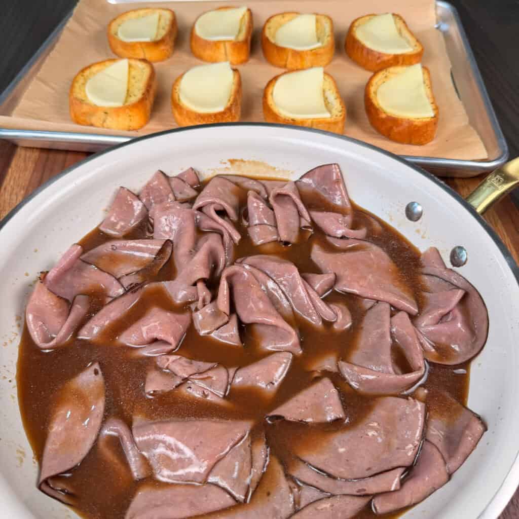Roast beef in Au Jus in a pan