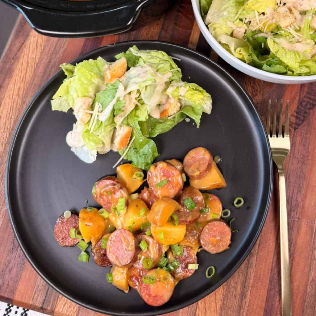 Plated kielbasa and potatoes with salad