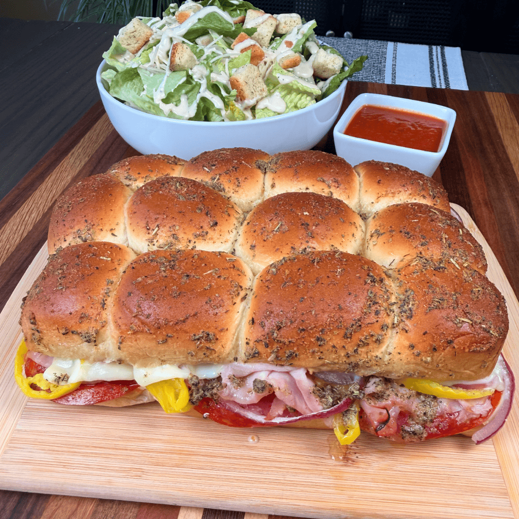Italian Sliders on cutting board with salad and marinara sauce