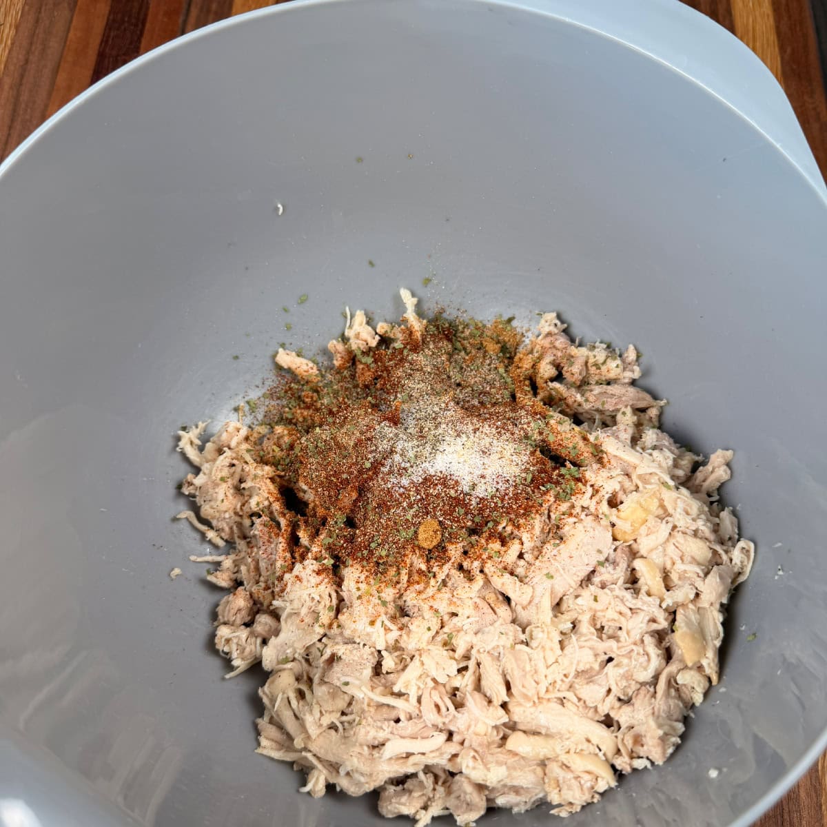 Chicken seasoned with taco seasoning in a bowl