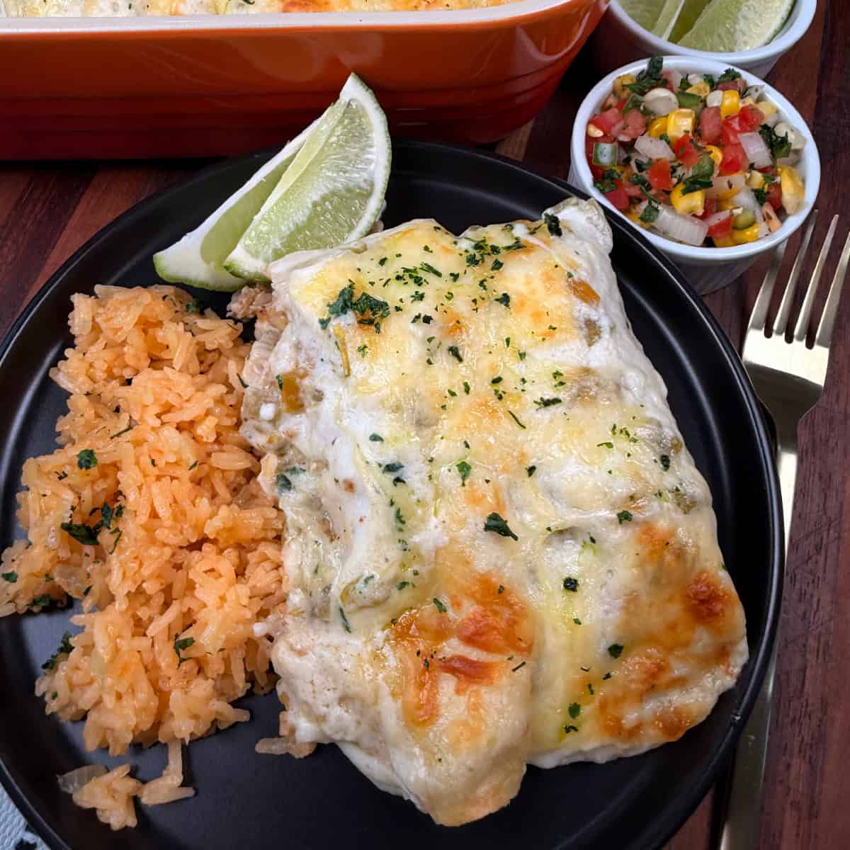 Plated enchiladas with rice and limes