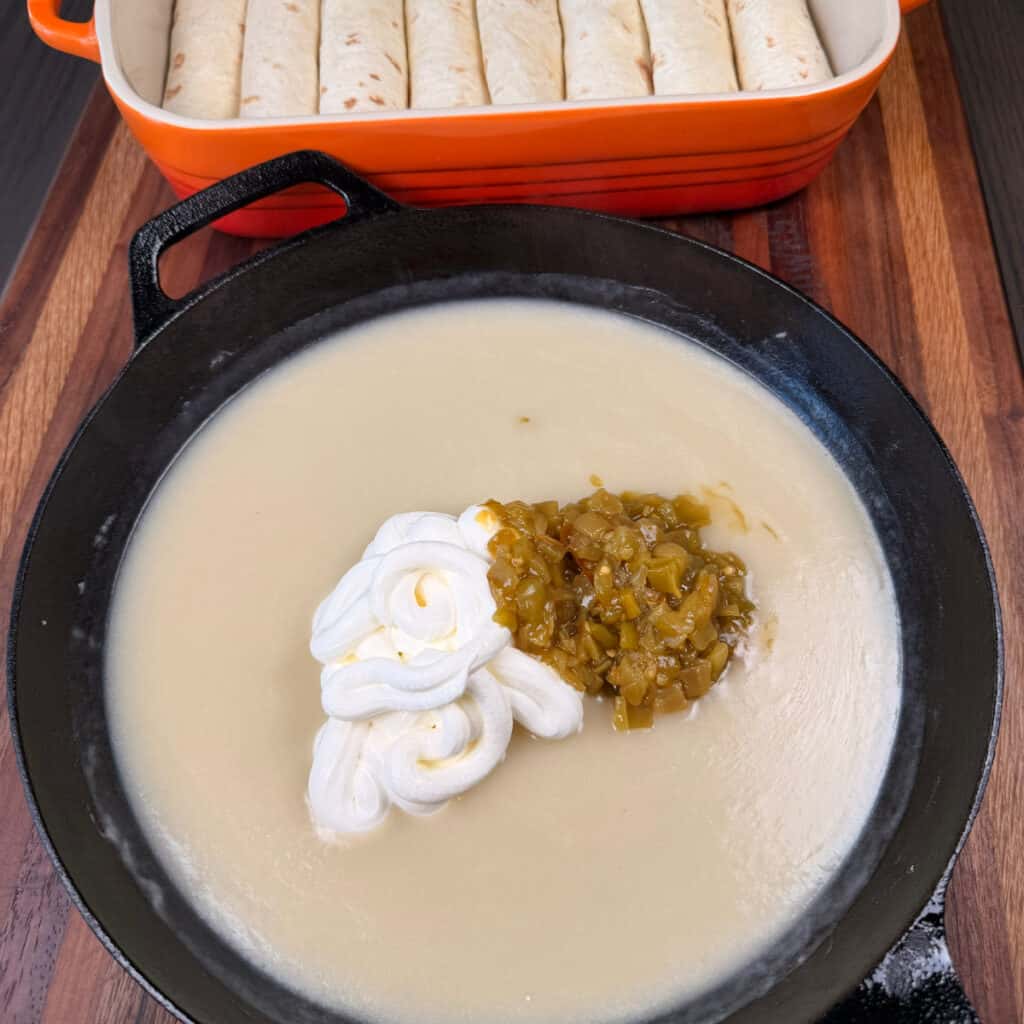 Skillet of sauce with sour cream and green chilies to be stirred in pan