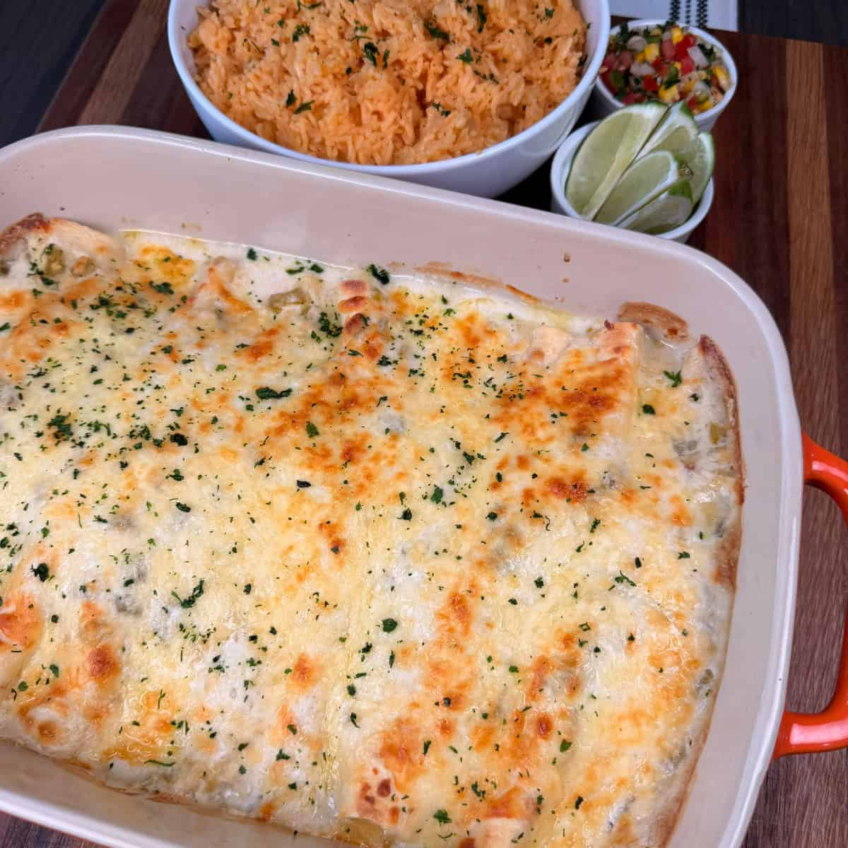Chicken Enchiladas with rice, limes, and Pico de gallo
