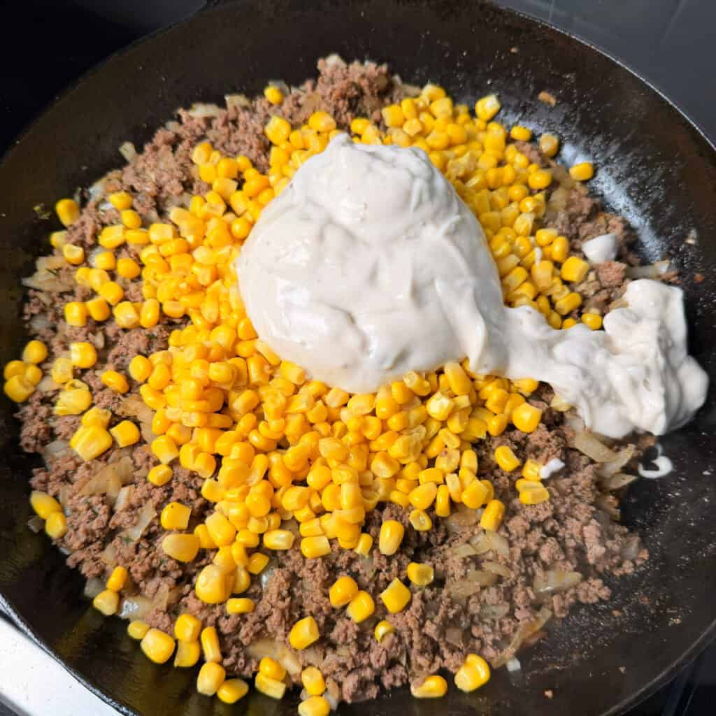 Browned beef, corn, cream of mushroom in skillet