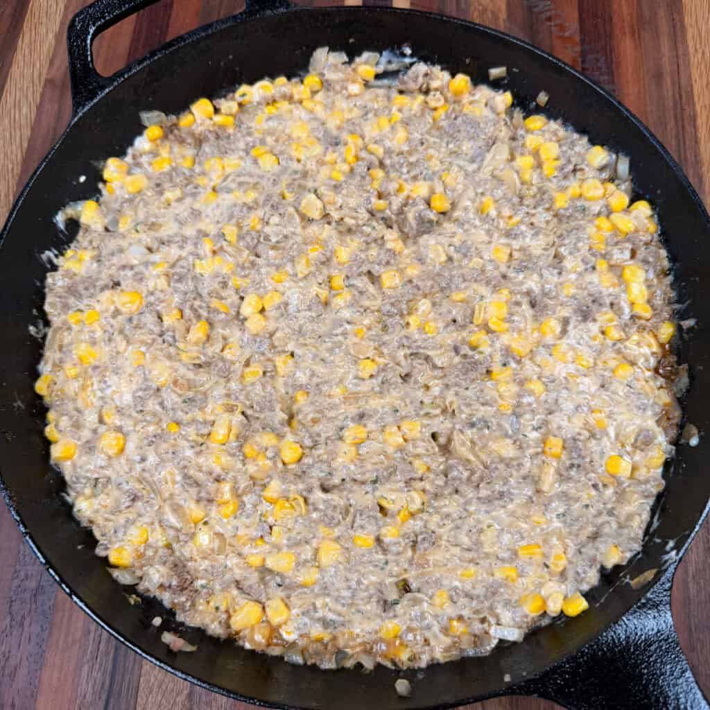 browned beef, corn, cream of mushroom spread evenly in skillet