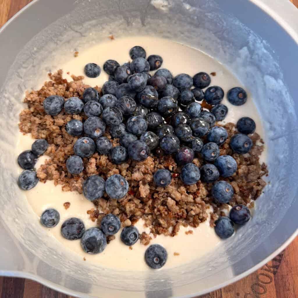 Bowl of pancake mix, syrup, sausage, and blueberries