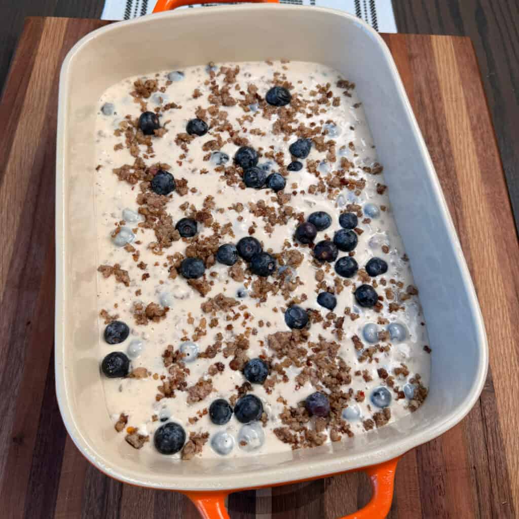 Baking dish of unbaked blueberry sausage pancake casserole