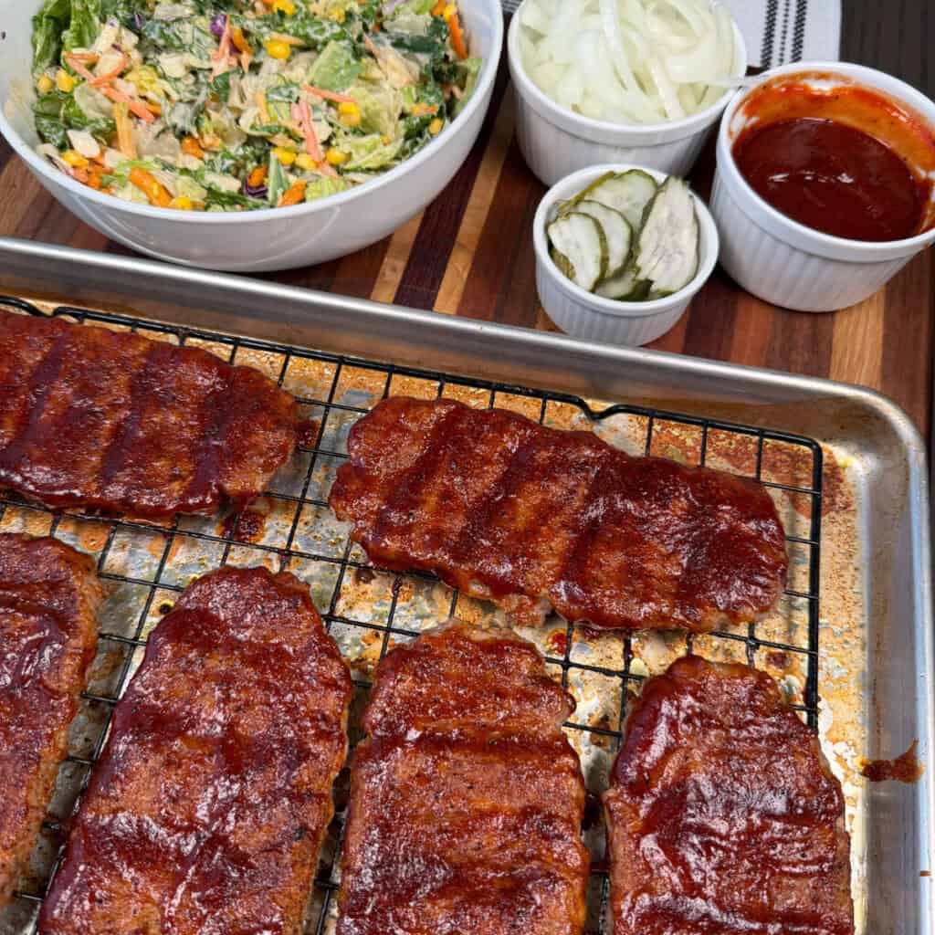 Sauced McRibs on a sheet pan with a wire rack