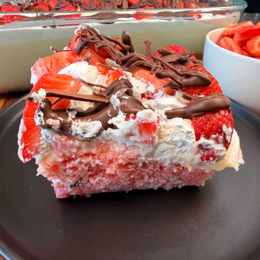 Slice of Chocolate Covered Strawberry Poke Cake