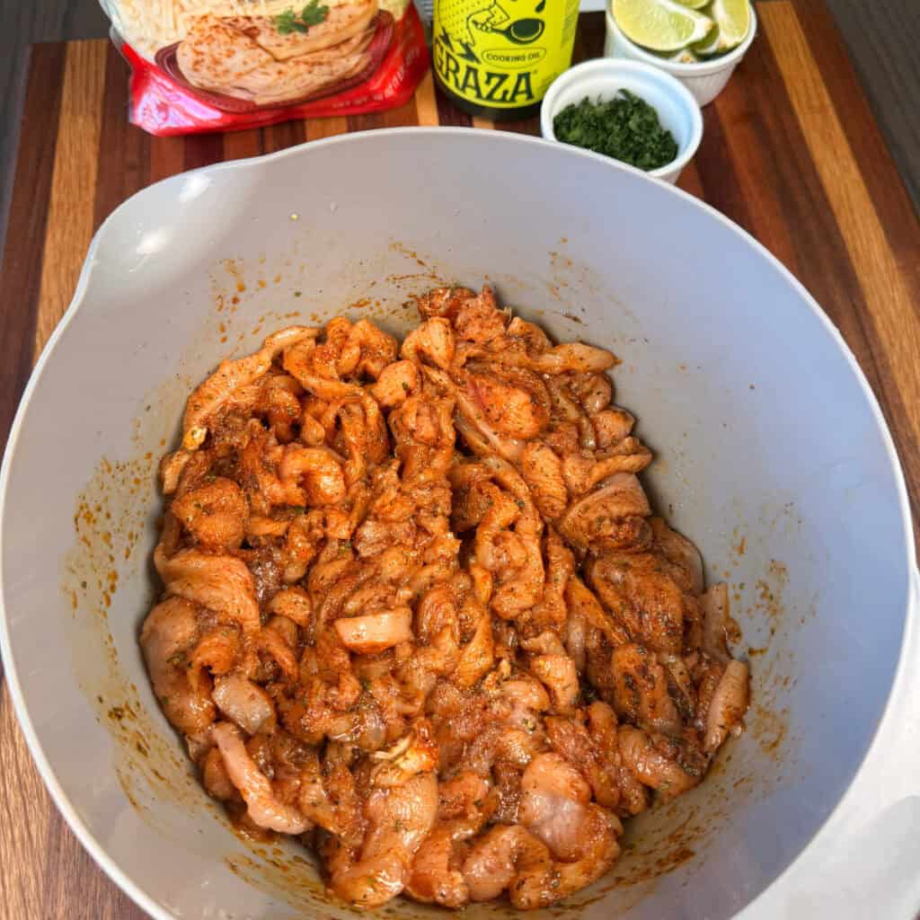 Bowl of cut up seasoned chicken