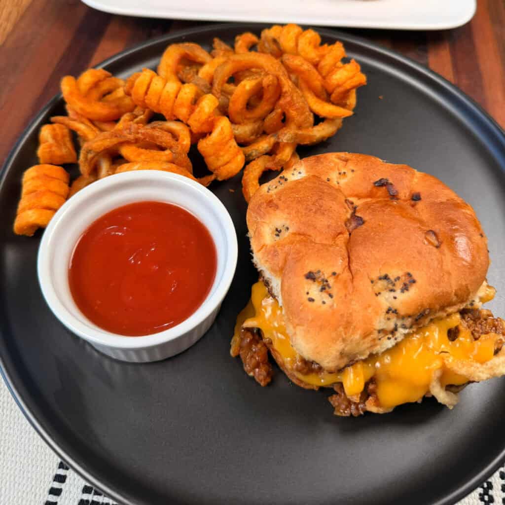 Plated Beef and Cheddar Sloppy Joe with curly fries