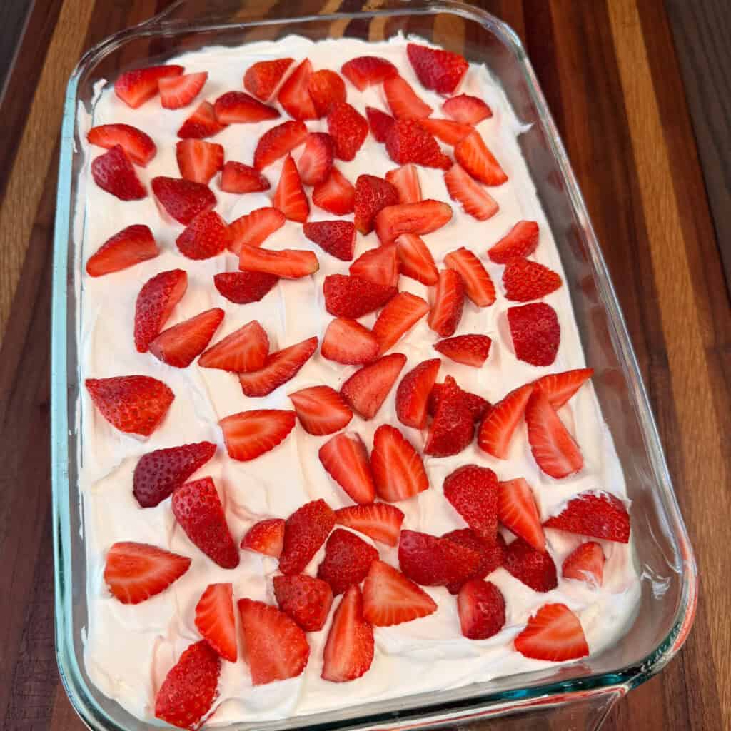 Strawberry Cake topped with whip cream and strawberries