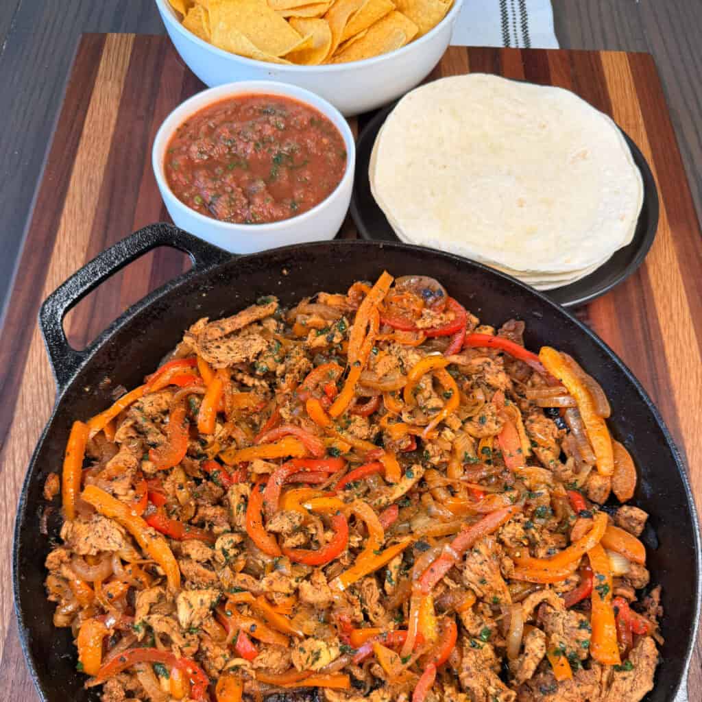 Chicken Fajitas with salsa, chips, and tortillas