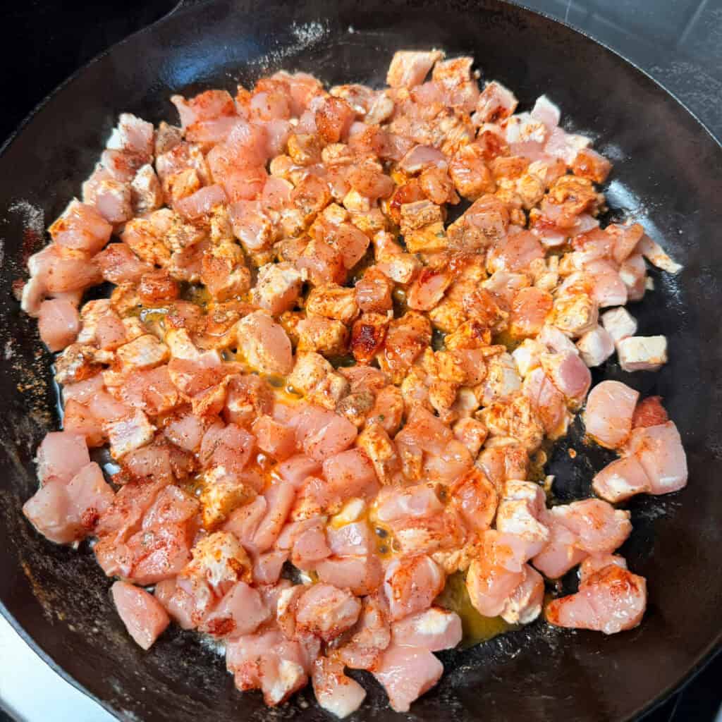 Seasoned chicken in skillet