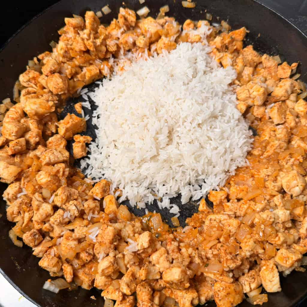 Cooked chicken with rice in skillet