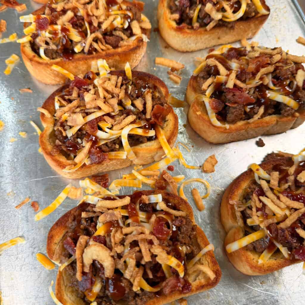 BBQ Cheeseburger Garlic Toast on baking sheet