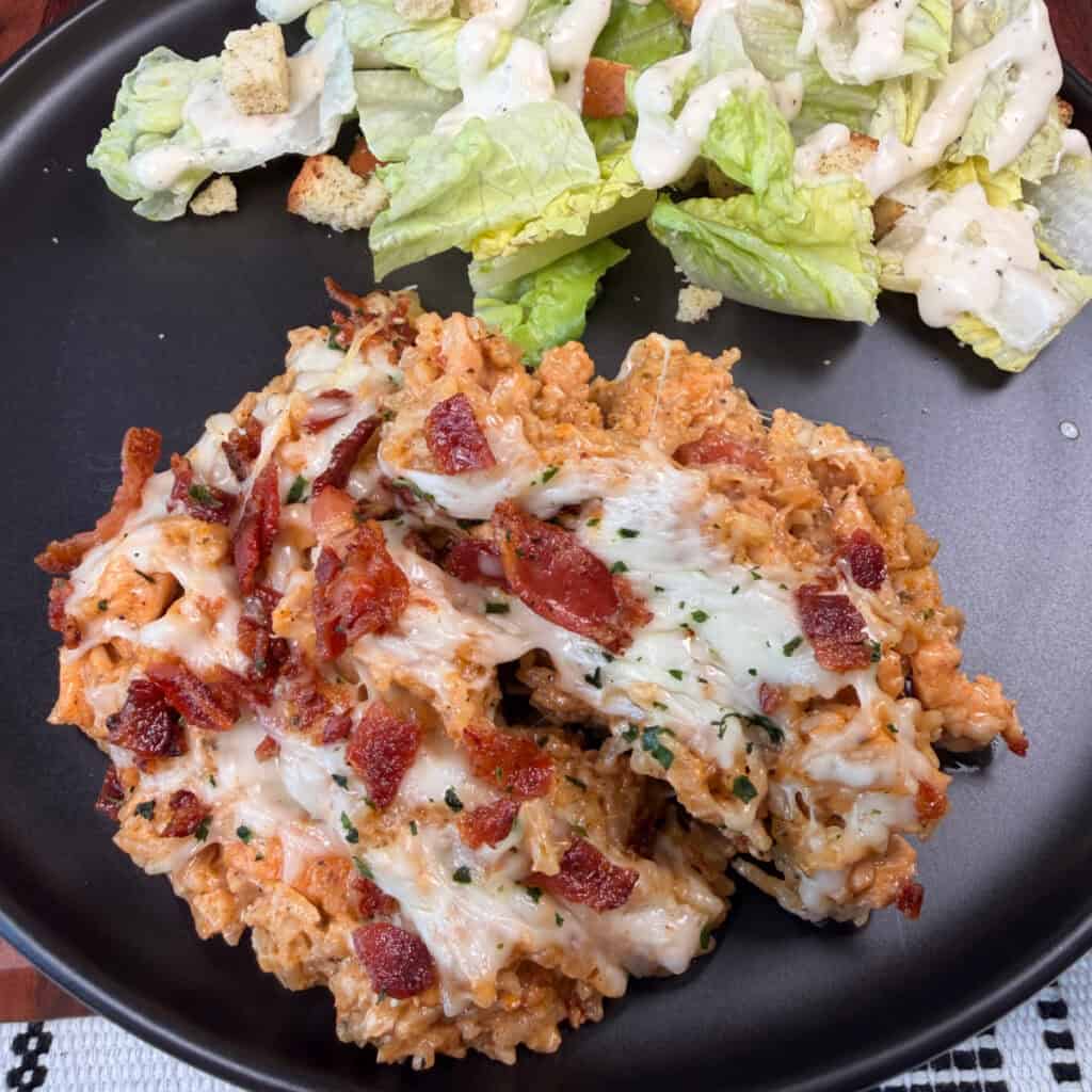 Plated Parmesan Garlic Chicken and Rice with salad