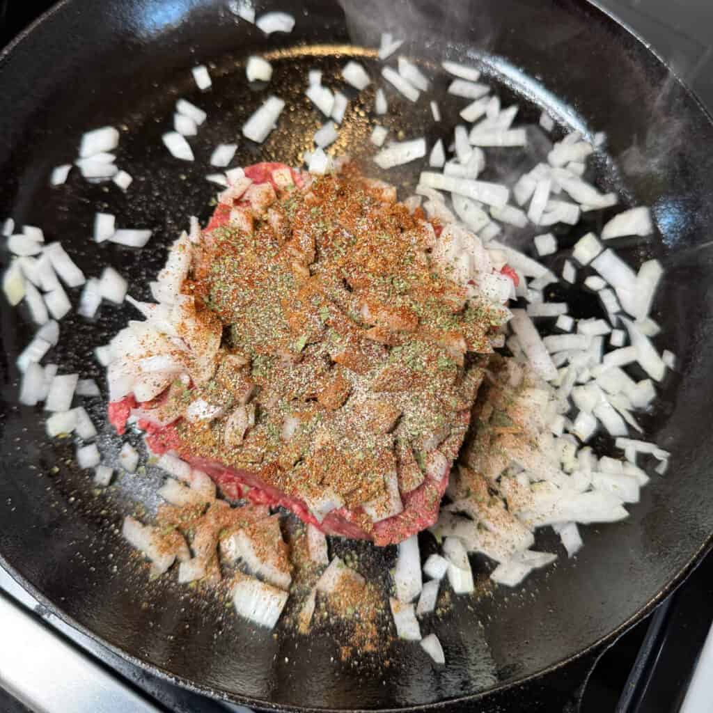 Ground beef with seasoning and chopped onion