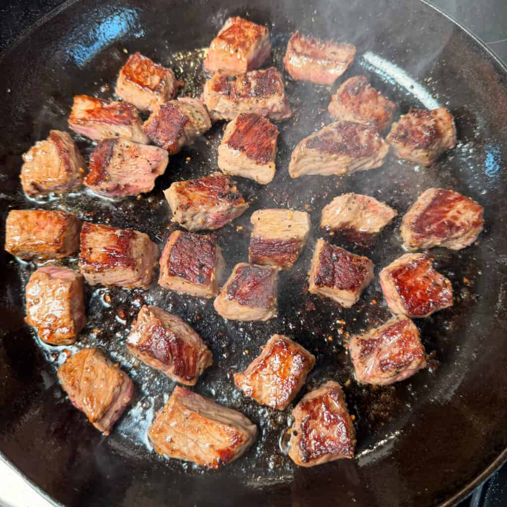 Searing the steak bites