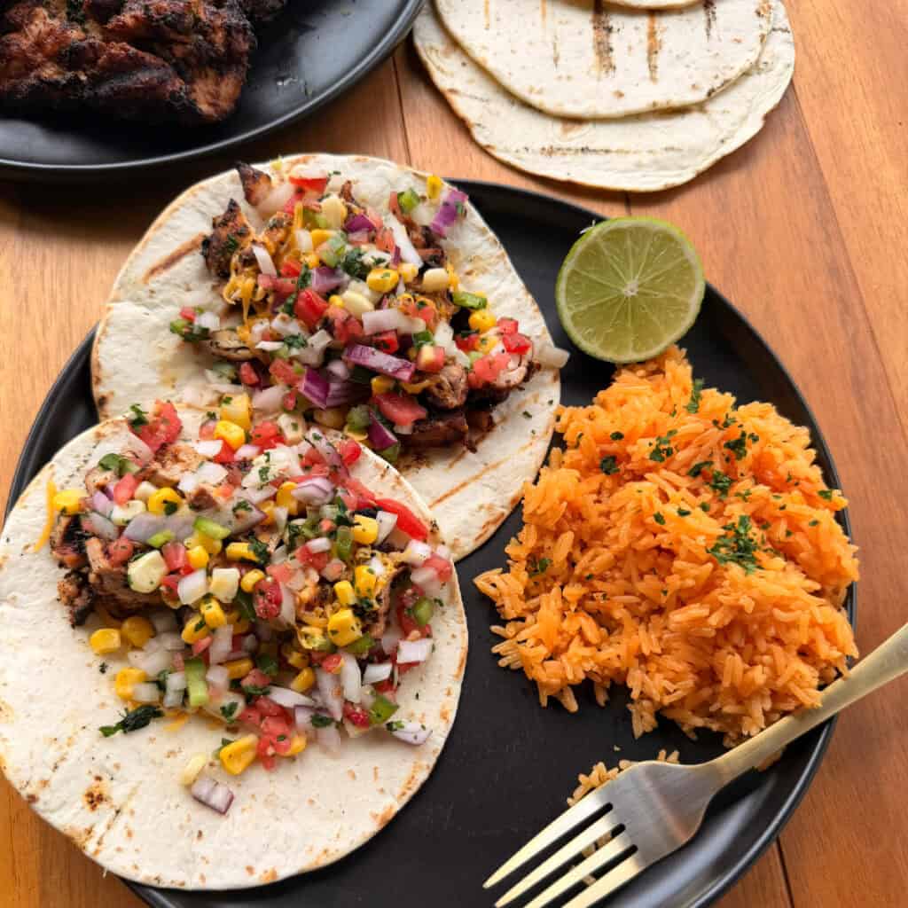 Chicken Thigh tacos plated with rice