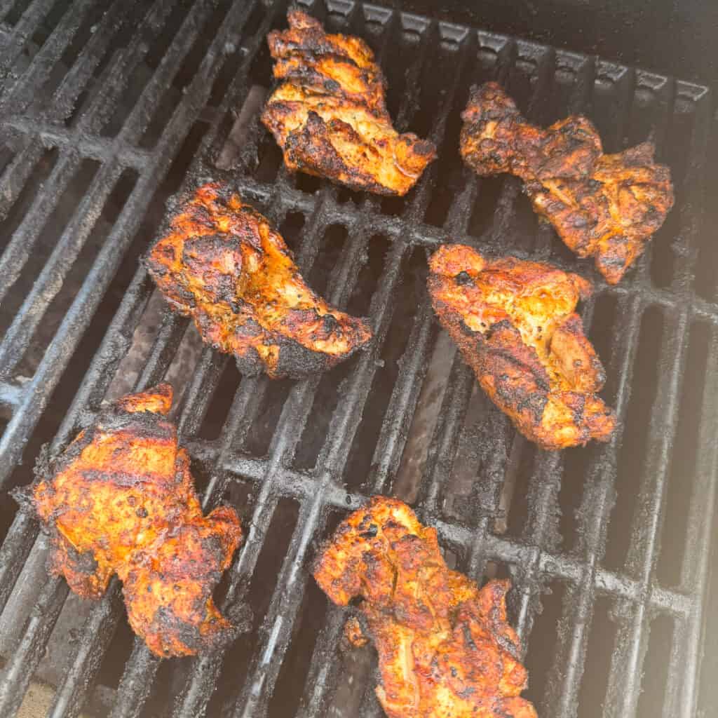Chicken Thighs cooking on a grill