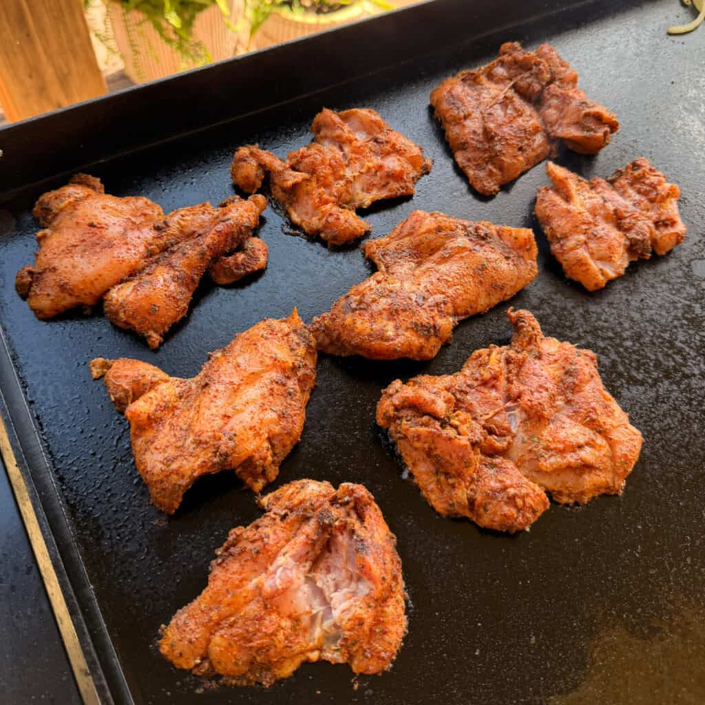 Chicken Thighs cooking on a griddle