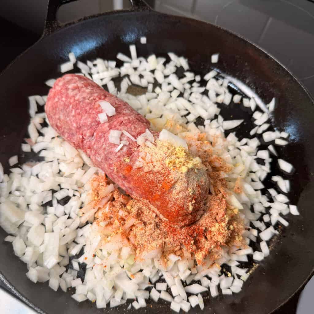 Ground beef, onions, seasoning in a skillet