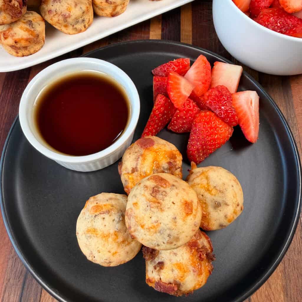 Mini Loaded Breakfast Pancake Bites with syrup on a plate