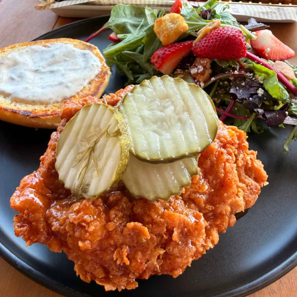 Plated Hot Honey Butter Chicken Sandwiches with salad