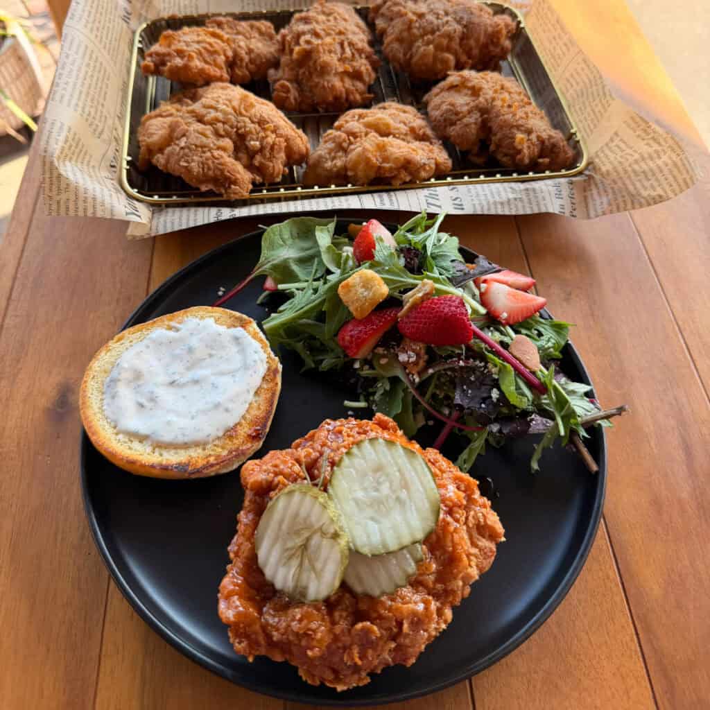Plated Hot Honey Butter Chicken Sandwiches with salad