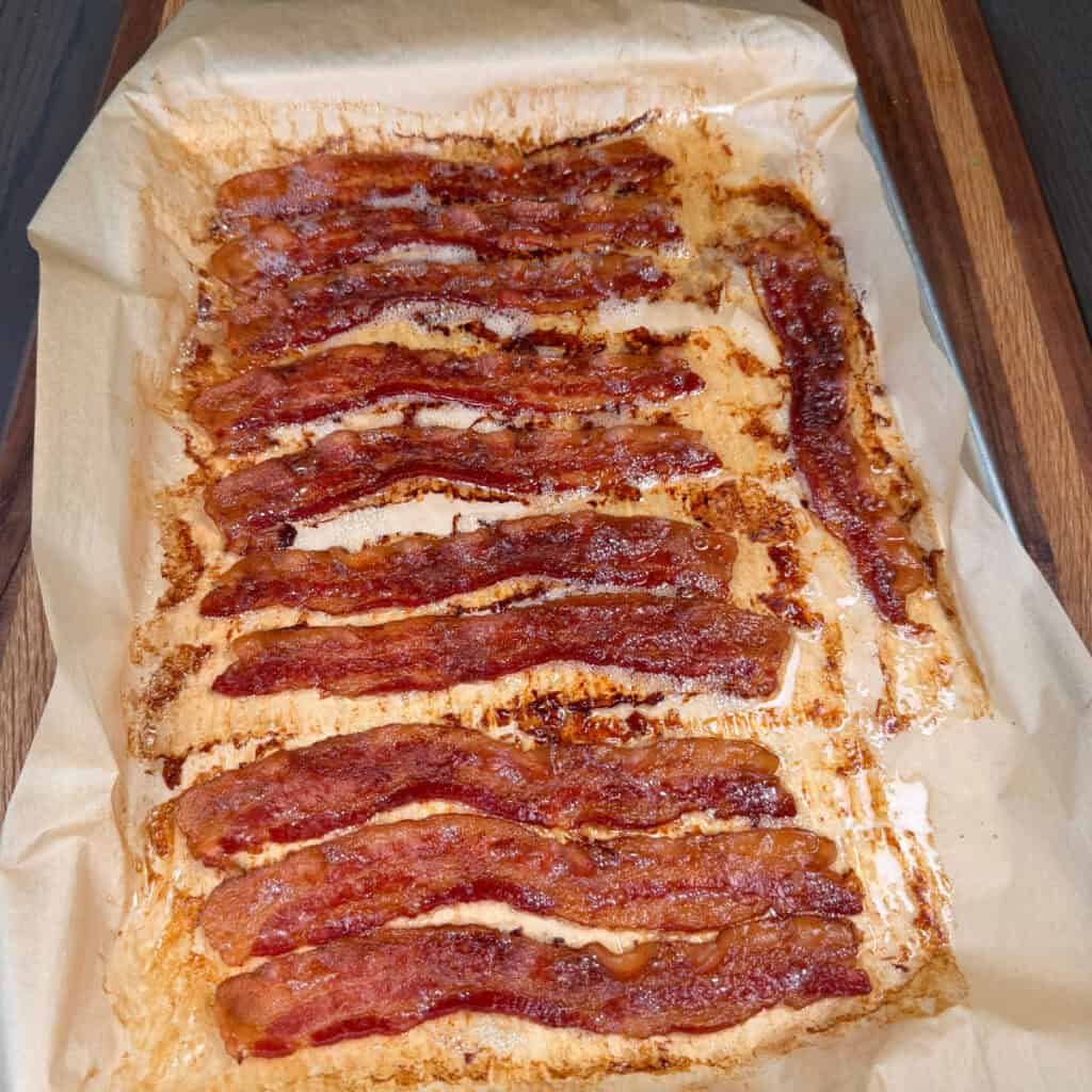 Bacon cooked on sheet pan lined with parchment paper