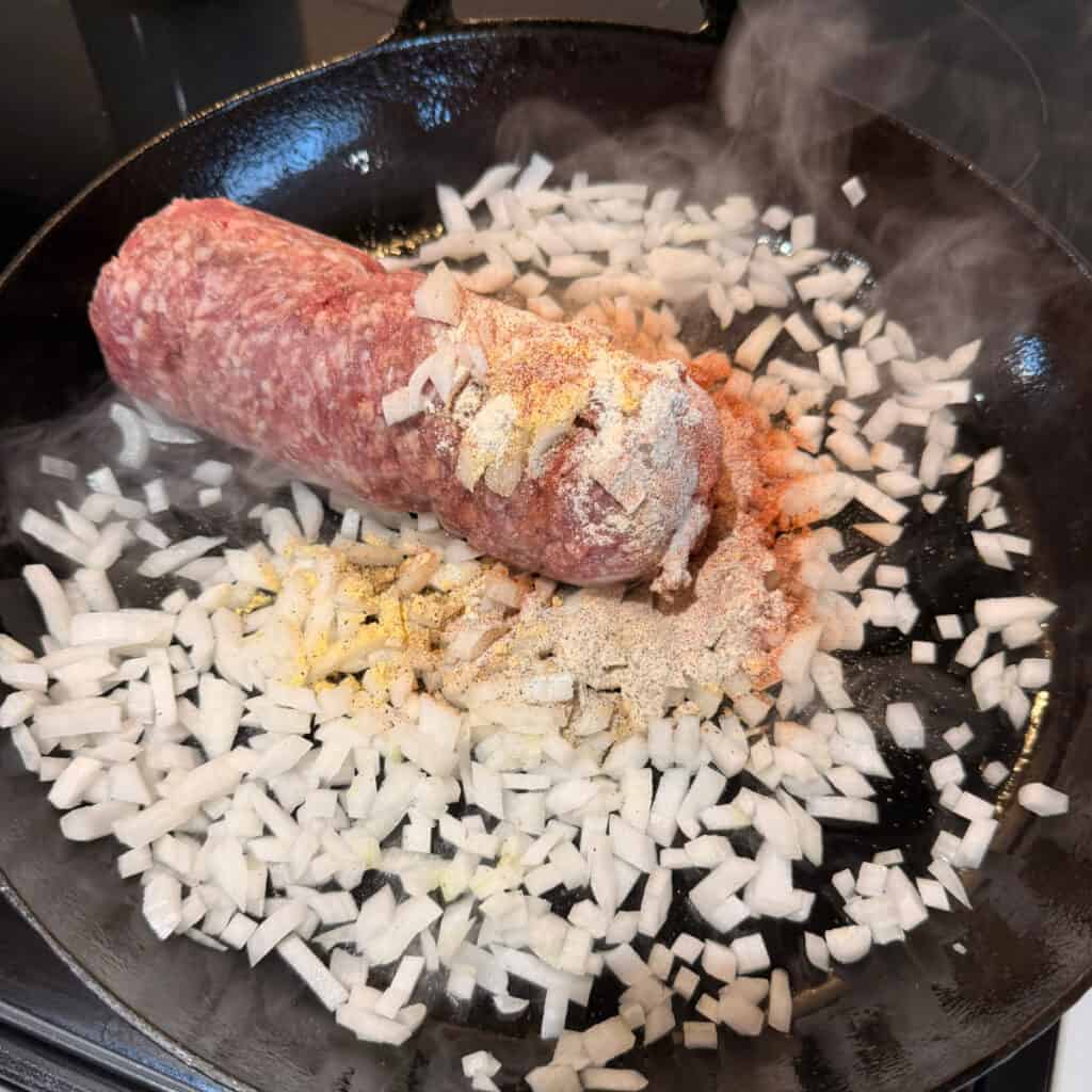 Seasoned ground beef with onions in a skillet